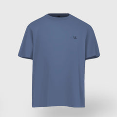 Blue t-shirt with a small logo on a light gray background